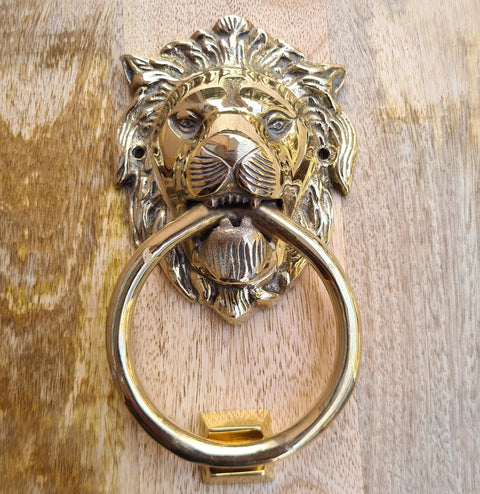 Vintage Brass Lion Door Knocker And Gate Pull With Solid Brass Finish Embossed Lion Mouth Design Traditional Door Accessory For Home Decor Entryway Accent 7 X 4 X 2 Inch close-up showing intricate details against wooden background.