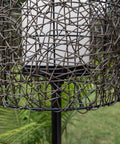 Close-up of Tanglewood Outdoor Floor Lamp in Oil Rubbed Bronze showing frosted bulb shield and decorative metal mesh design.