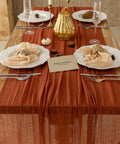 Rustic Fall Thanksgiving Table Runner Terracotta Cheesecloth Weave 120 Inches Long Hand Dyed Soft Cotton Gauze on dining table.
