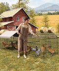 Woman tending poultry in heavy duty metal chicken run and coop system with 86 inch or 130 inch lengths portable outdoor cage, farm backdrop
