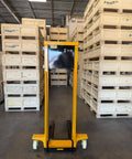 Self Loading Electric Pallet Stacker With 2116 Lbs Capacity And 51 Inch Lift Height in warehouse surrounded by wooden pallets.