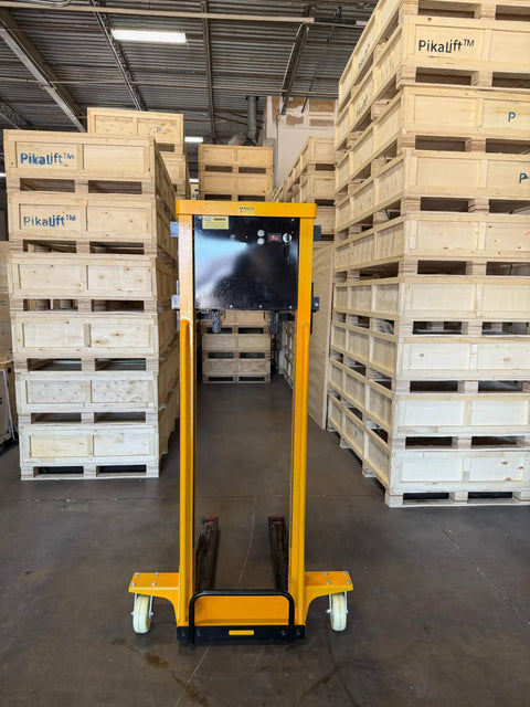 Self Loading Electric Pallet Stacker With 2116 Lbs Capacity And 51 Inch Lift Height in warehouse surrounded by wooden pallets.