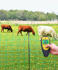 Backlit LCD Electric Fence Voltage Tester With Fault Finder, 200V To 15,000V Range, 15KV Digital Fence Tester in use with cows grazing