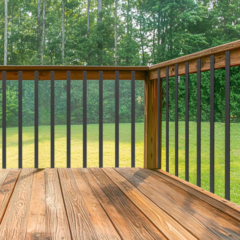 Built Tough Sixty One Pack Heavy Duty Black Metal Deck Balusters Plus Mounting Bolts 32 Inch installed on wooden deck.
