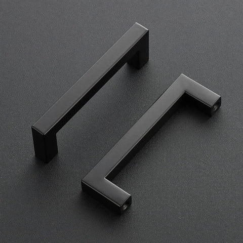 Slick Matte Black Square Bar Cabinet Handles 4 Inch Hole Center Pulls For Kitchen Cabinets And Drawers on a dark surface