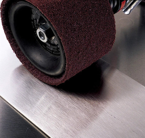 Surface Conditioning Belt For Metal Finishing 1/2 In By 18 In Nonwoven A CRS Grade Reduces Loading And Heat Build Up Delivers Consistent Finishing Blending And Light Deburring 20 Belts Per Case is shown in use on metal surface.