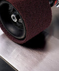 Surface Conditioning Belt 1 In By 42 In A VFN Pro Grade Abrasive Nonwoven Belt in use, shown cleaning metal surface efficiently