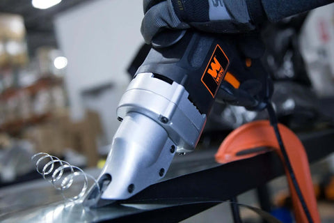 Heavy-Duty Metal Shear with Swivel Head cutting sheet metal, variable speed, 4-amp power, precise pro-grade cuts visible