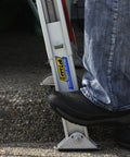 Complete Ladder Leveler Stabilizer Kit with Quick Connect extends 10 inches for safe use on uneven ground, mounted on a ladder.