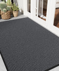Gray Heavy Duty Front Door Mat 3 By 5 Feet Outdoor Entrance Rug with Non Slip Backing shown in an entryway setting.