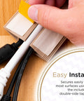 Installing 6Ft Floor Cord Cover Cable Protector for open floors with tan finish using double-sided tape, showing cavity and cables inside.