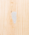 Fix It Multi Purpose Epoxy Putty 4 Oz Beige Gray applied on rough wooden surface for DIY repairs