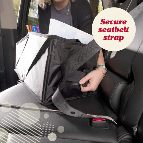 Backseat Car Organizer With Built In Cup Holders And Mesh Pockets Foldable With Handles 9 Compartments Road Trip Essential For Busy Families Kid Friendly Black Oxford Finish shown secured with seatbelt strap on car seat.