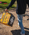 Person carrying Yellow Jacket Dual Threat Foam Archery Target Block Up To 350 FPS For Compound Bows And Crossbows Four Sides