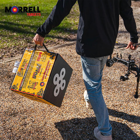 Person carrying Yellow Jacket Dual Threat Foam Archery Target Block Up To 350 FPS For Compound Bows And Crossbows Four Sides