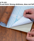Hands peeling Walnut Wood Grain Peel And Stick Contact Paper Self Adhesive Vinyl Waterproof Removable DIY with Grid Lines