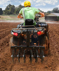 Person using 28 Inch Disc Plow Harrow With 2 Inch Receiver For ATV UTV Pull Behind Tiller Black Heavy Duty Ground Prep Tool in field