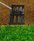 72-Inch Lawn Leveling Rake With Stainless Steel Handle leveling soil on lawn for even surface, heavy duty yard leveler in action.