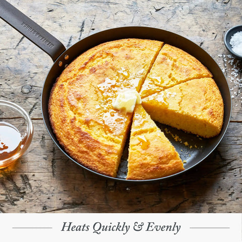 Budget-Friendly Carbon Steel Frying Pan 12 Inch Pre-Seasoned with cornbread on a wooden table, showing even heating