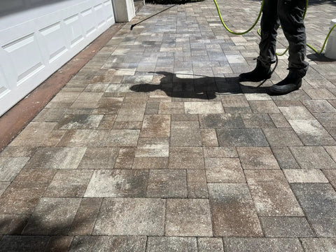 Person applying Heavy Duty Eco Friendly Paver Sealer For Brick And Concrete Low Lustre Formula on pavered driveway.