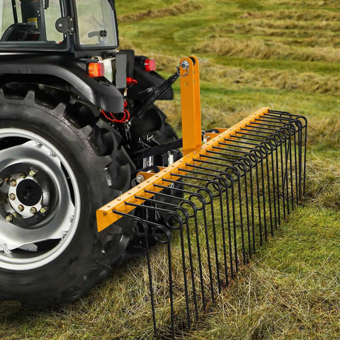 60 Inch Heavy Duty Powder Coated Steel Pine Straw Rake With 26 Spring Steel Tines attached to tractor in field