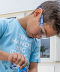 Child wearing Kids Blue Safety Glasses Lightweight Protective Eyewear For School And Lab Use Comfortable All Day Fit