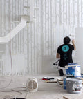 Person using Birch Forest Wall Stencil XL 24x37 In For Large Pattern Painting on a big wall with seamless edges. Modern boho home decor DIY scene.