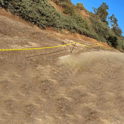 164 Feet High Visibility Plastic Chain Barrier For Crowd Control And Parking Safety on a dirt slope