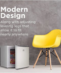 Compact Upright Freezer One Point Two Cubic Feet Portable Chill Station beside a yellow chair in a modern space.