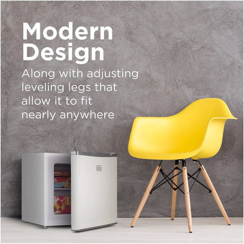 Compact Upright Freezer One Point Two Cubic Feet Portable Chill Station beside a yellow chair in a modern space.