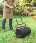 Man using 20 Inch Push And Tow Behind Lawn Roller Filled With 10 Gallons Of Water Or Sand, Heavy Duty Yard Roller For Flattening Sod And Uneven Patches In The Garden, Black.