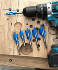 Top Shelf Six Piece Auger Drill Bit Set With Quick Change Quarter Inch Hex Shank Self Feeding Wood Boring Bits for hardwood and softwood shown with an impact driver.
