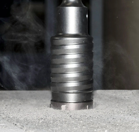 SDS-Max Hammer Core Bit 1-1/2 In By 11-3/8 In Steel drilling concrete, showing outer flute reducing friction and dust.