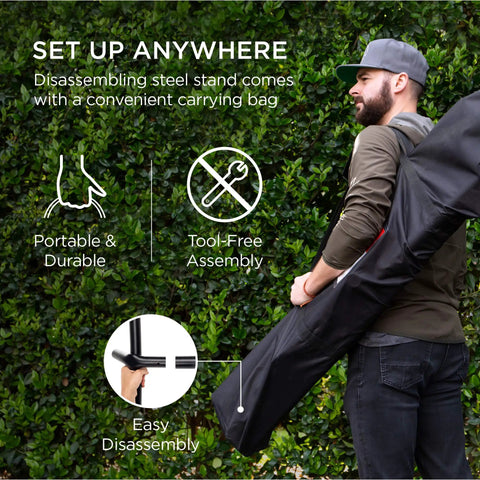 Man carrying Two Person Indoor Outdoor Hammock With Steel Stand Cozy Brazilian Gathered End Style Cotton Bed For A Cocoon Vibe Carrying Bag Included Blue Green Stripes.