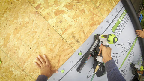 Image of Solid Grip 1 Inch Plastic Cap Staples 2000 Ct Spool being used in pneumatic stapler for housewrap installation.