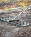 Stainless Steel 30 Inch Lawn Level Rake Pro Grade Yard Tool For Even Grass And Smooth Soil Leveling on dirt surface