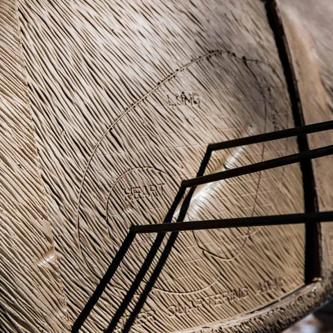 Crossbow Buck Replacement Core With Open Layered Polyfusion Technology, close-up of arrow impact marks on brown target surface