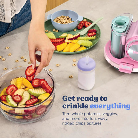 Five In One Food Prep And Storage Bowl System With Crinkle Slicing Shredding Functions, displaying crinkle-cut fruits in a glass bowl.
