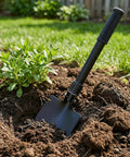 16 Inch Heavy Duty Mini Shovel With Curved D Handle Portable Spade in garden soil beside green plant