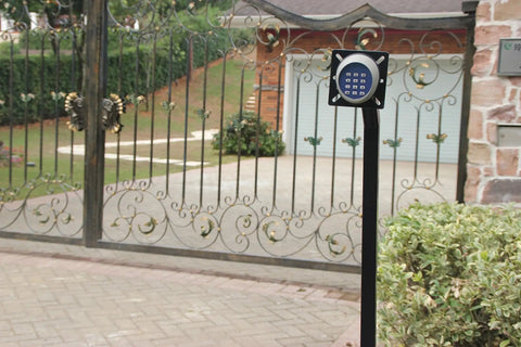 Wireless Gate Keypad With Keyless Entry Numeric Code Panel For Automatic Swing Or Sliding Gate Opener Outdoor Security Access Control Quick Pass Function And No Key Needed For Easy Pass Through mounted on post by ornate gate