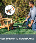 Person using 20V Cordless Yard Work Ready Bundle 12 Inch Trimmer Edger for hard-to-reach grass under chair