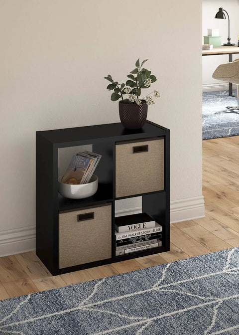 Open Back 4 Cube Storage Organizer In Black Built With A Sturdy Frame And Finished On Front And Back Perfect For Living Room Or Closet Organization Accepts 13 Inch Fabric Bins Easy Assembly displaying two bins and decor items