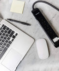 Six-Outlet Surge Protector Power Strip With 10-Foot Braided Cord And Flat Plug, 1080 Joules, ETL Listed, on office desk.