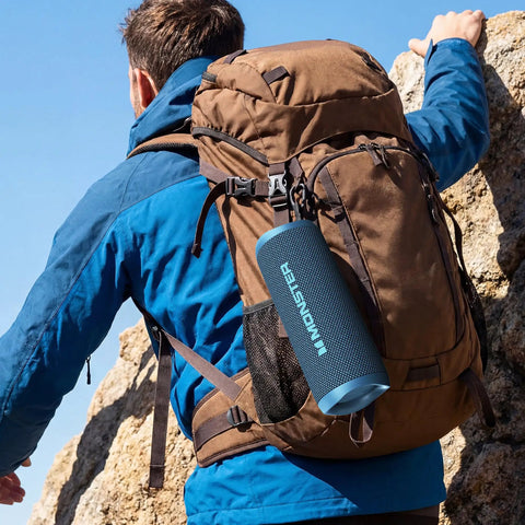 Beast 60W Portable Outdoor Bluetooth Speaker With True Wireless Stereo, IPX8 Waterproof, attached to a hiker's backpack