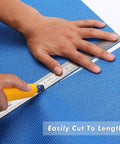 Hands cutting Blue Non Slip Foam Rubber Drawer Liner For Tool Boxes And Drawers, Easy Cut With Textured Grip, 16 Inch Wide.