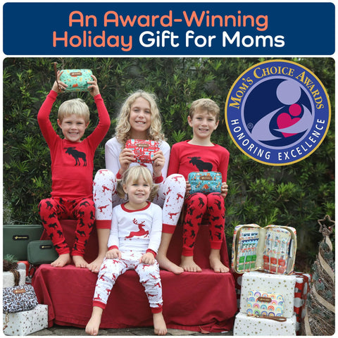 Group of children in red and white holiday pajamas holding small travel first aid kits; Mom's Choice Awards badge visible.