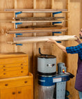 Four Tier Lumber Rack Wall Mounted Shop Organizer For Garage And Basement, holding lumber in a workshop setting.