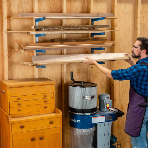 Four Tier Lumber Rack Wall Mounted Shop Organizer For Garage And Basement, holding lumber in a workshop setting.