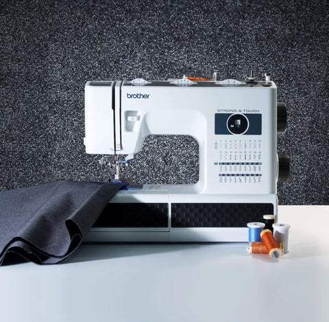 No Sweat Dead Simple Sewing Machine With 37 Built In Stitches And Automatic Needle Threader, white with fabric and thread spools.