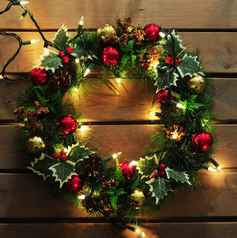 Festive wreath with Make Your Holiday Lit With A 35 Count Clear Extra Bright Mini Christmas Lights Set, decorated in red and gold.